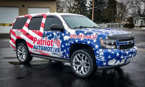 Full SUV vehicle wrap with American flag design for Patriot Automotive in Spokane, printed and installed by Signs for Success